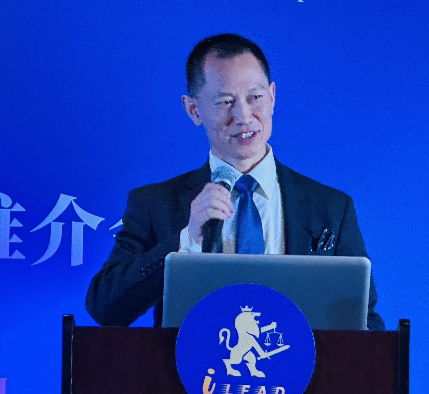Attorney Mingli Chen, Chairman of iLead Law Group, speaks at the ceremony