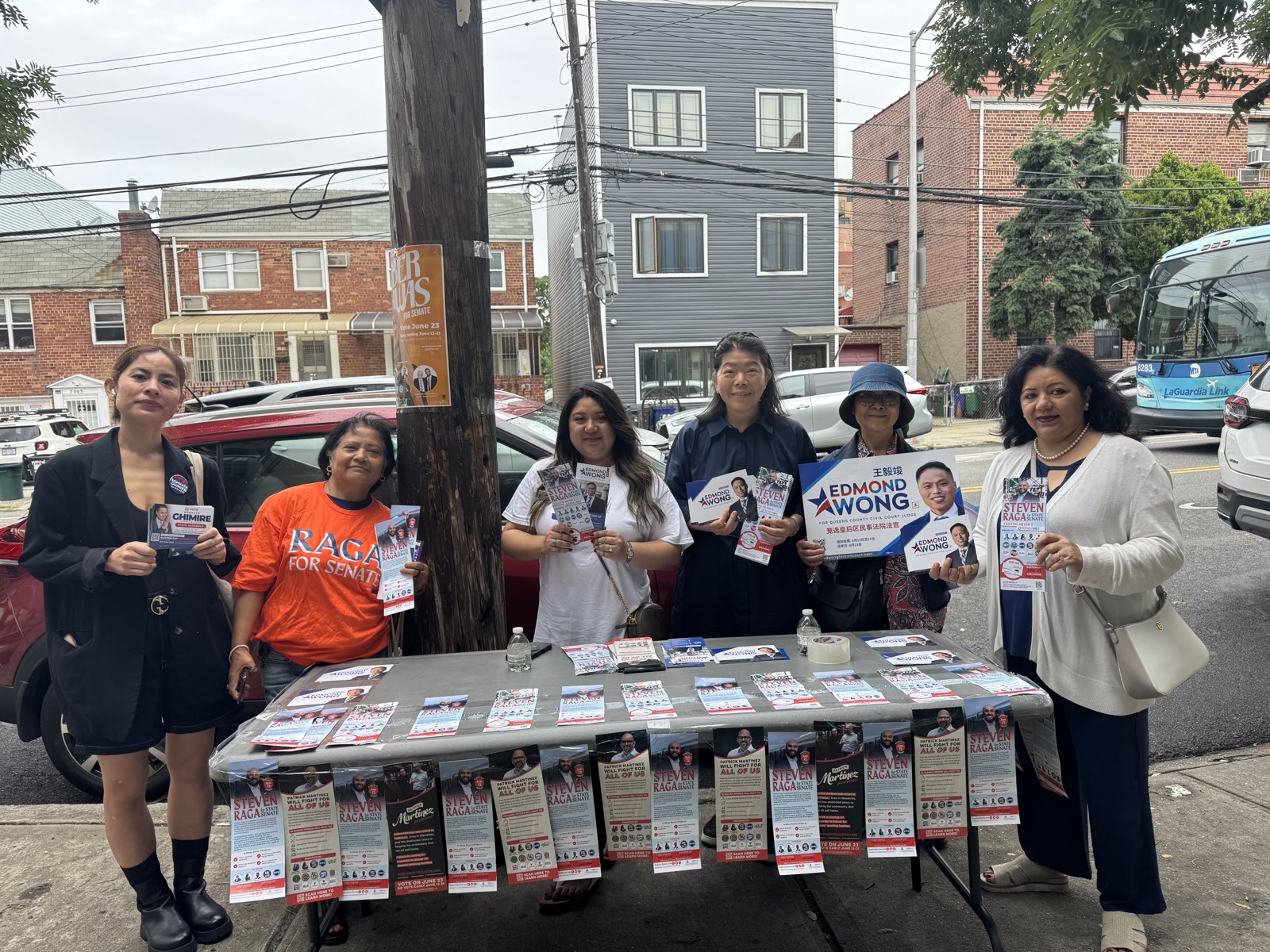 Volunteers staffing a street table for the Edmond Wong campaign in Queens