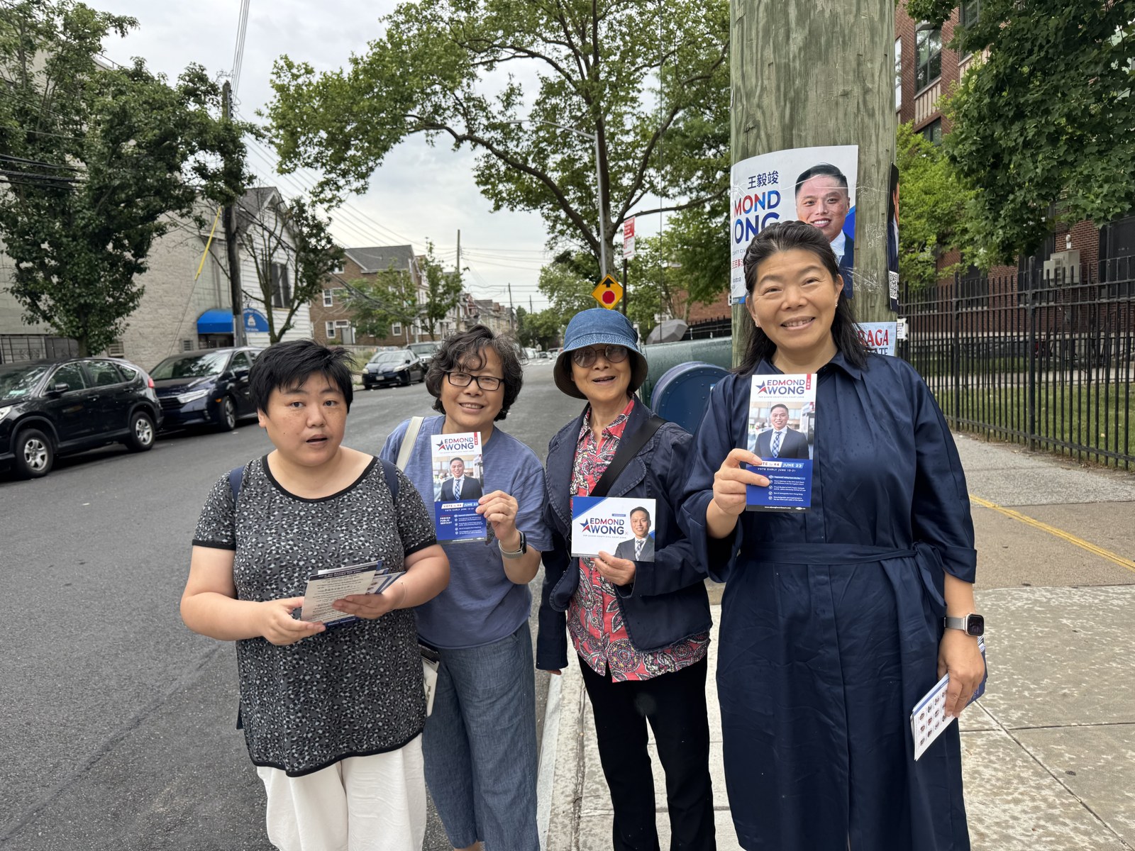 Supporters hand out campaign flyers for Edmond Wong
