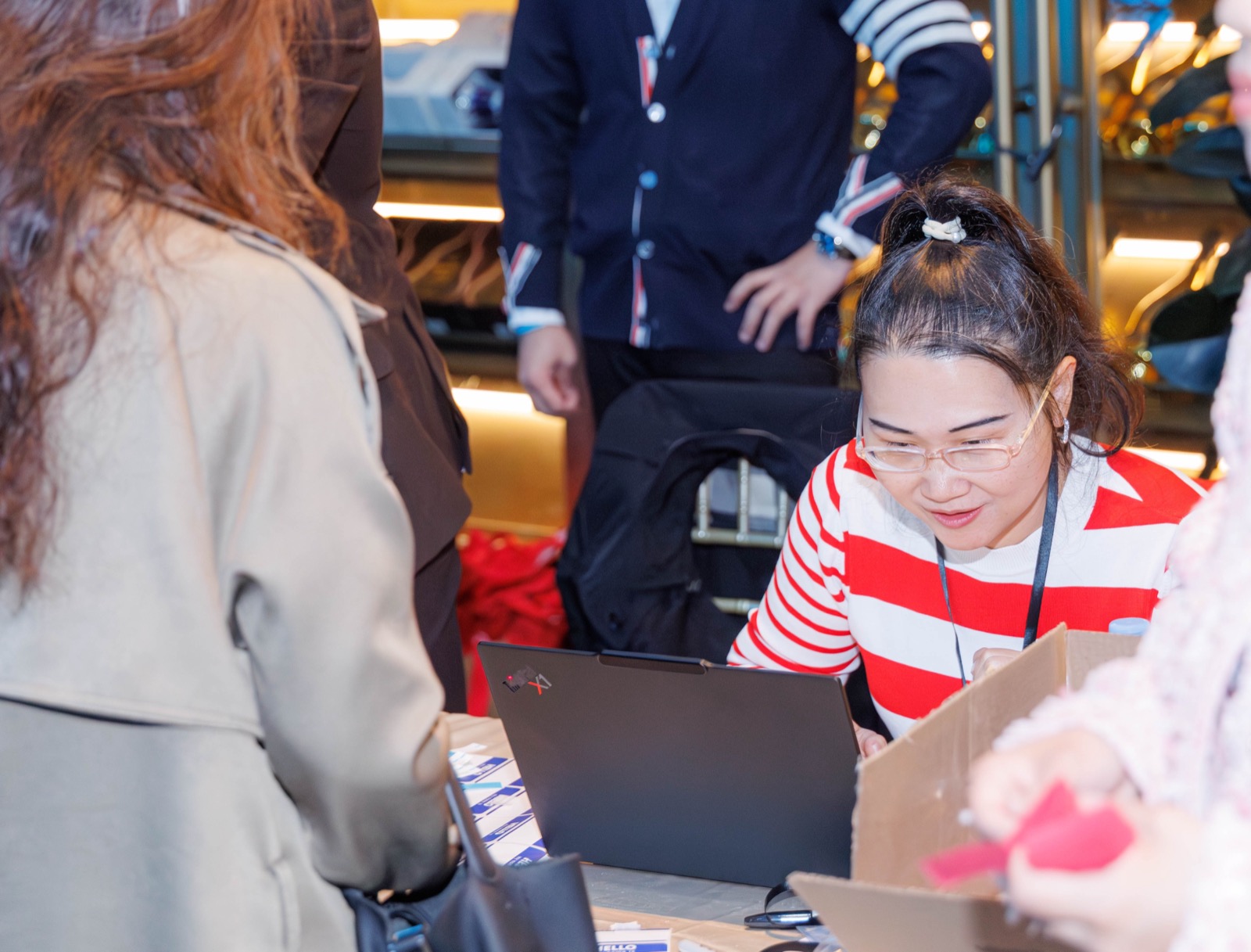Claire Jingjing Xue, AAAA Events Committee Director (in red), at the check-in desk