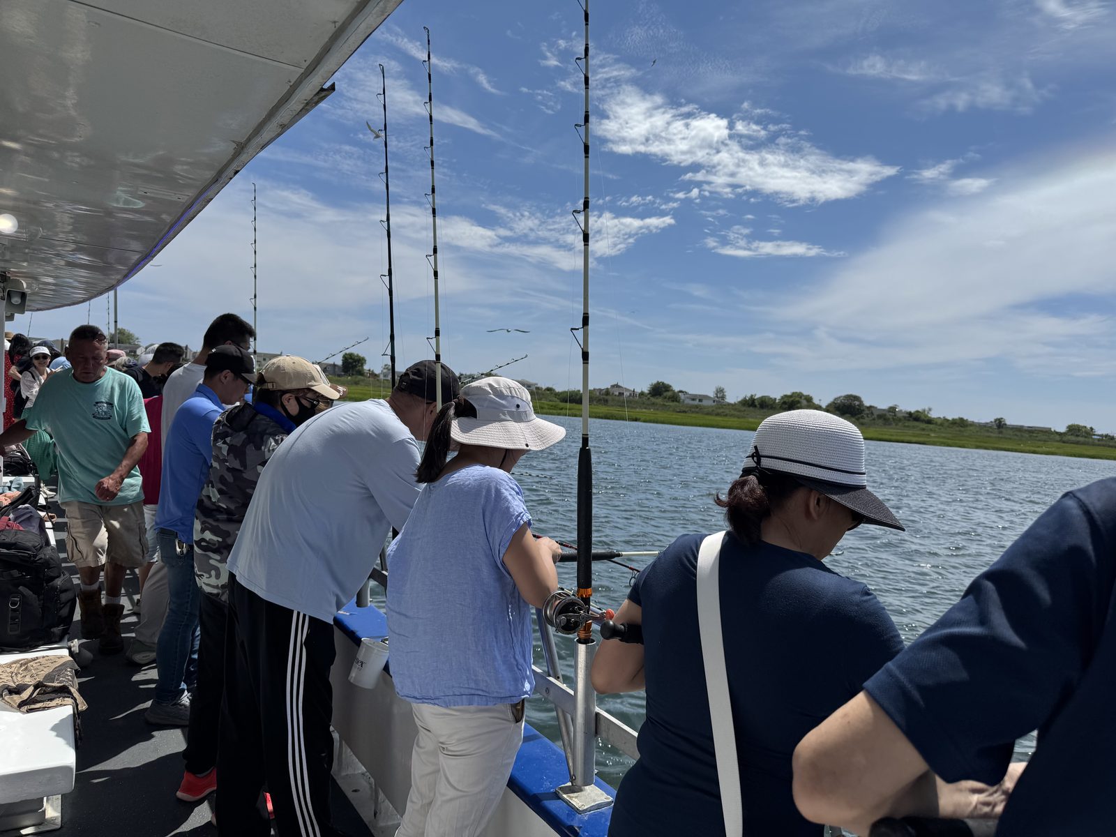 Anglers line the rail, rods out into the sea breeze